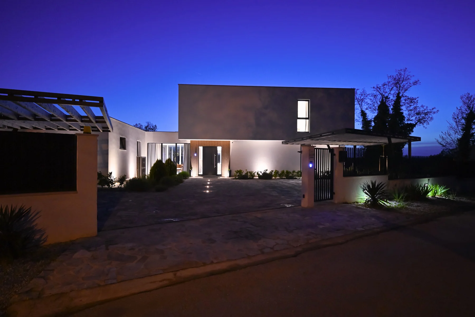 Modern luxury home illuminated at night